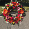 This 24&quot; open wreath is made of pinks, orange, yellow and a