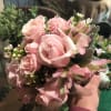 A Soft mix of pink roses, pink spray roses, pink alstroemeria, wax