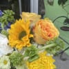 This beautiful arrangement has, yellow sunflowers, yellow roses, white hydrangea, green bells