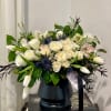 Beautiful Ivory roses, lush greens arranged with other premium and seasonal florals