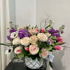 Beautiful blush roses, jeweled toned stock, and lush greens arranged with other