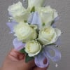 White rose corsage with white sheer ribbon and rhinestones.