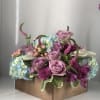 Hydrangeas, roses, carnations, assorted fillers and foliage beautifully arranged in a wood
