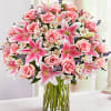A large, elegant vase of all shades of pinks and some whites