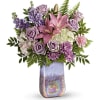 This lavender artisan vase is filled with the finest feminine flowers