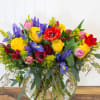 This dramatic bouquet includes bright yellow roses, vibrant red alstroemeria, striking blue