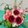A compact stylized arrangement of premium flowers such as hydrangea, roses, lilies