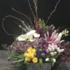 Spring mix arranged in a garden like setting in a container