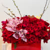 A box filled with roses and orchids