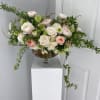 A grand arrangement of roses, garden roses, ranunculus, viburnum, hydrangea and hellebore
