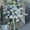 Standing spray of white hydrangeas, roses, peonies and hybrid delphinium