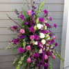 This easel spray beautifully mixes purple flowers with a white center of