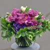 Sweet and simple arrangement of purple and lavender roses, green and white