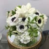 An adorable and quaint arrangement of white tulips and anemones...a perfect way