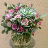 Designed in a cylinder vase, purple roses, hyacinths, fillers and a variety