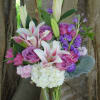 Fragrant lilies, stock, cherry blossoms, purple roses, hydrangeas fillers and greens in