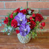 Red Spruce Roses and Blue Vanda Orchids abound in this luscious arrangement