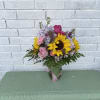 Mixed floral with sunflowers, roses, and a variety of filler flowers paired