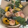 Korean wrapped bouquet filled with roses, sunflowers and fillers paired with butterflies