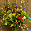 A colorful vibrant natural mix of seasonal blooms arranged in a clear