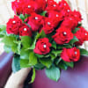 24 red roses, sparkling pins, greens, stems are wrapped with burlap.