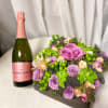 A sweet display of lavender, pink and green florals accompanied by a
