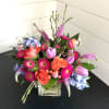 A lovely arrangement bursting with color and joy! A mixture of roses