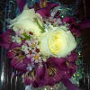 This wrist corsage is created with Roses, Alstroemeria, Wax flower, decorative ribbon