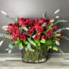 An impressive arrangement of 50 long stem red roses eloquently arranged in