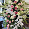 Funeral spray with pink roses snapdragons, orchids and lisianthus