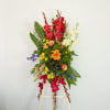 This colorful standing spray is made with a sunset-inspired color palette, and