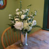 Silver mint julep container. Flowers included in season: Peonies, White freesia, White