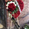 An mix of Red and white tribute, this heart funeral spray is