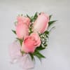 This beautiful corsage features three light pink roses along with a light