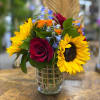 This beautiful arrangement is filled with sunflowers, roses, garden roses, blue delphiniums