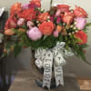 Thoughtfully arranged bouquet of colorful flowers such as orange roses, pink roses