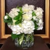 A mix of white roses, hydrangea, orchids and other seasonal white flowers