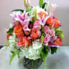 Soft and fun mix of peach and pink flowers perfect for bringing
