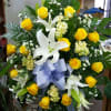 Golden yellow roses, white lilies and butter cream stock with accent of