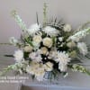 Pure white sympathy basket with white roses, fuji moms, carnations snap dragons
