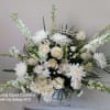 Pure white sympathy basket with white roses, fuji moms, carnations snap dragons