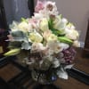 A Grand full arrangement of lilies, roses, orchids and other season flowers.