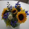 IN SEASON ~ 5x5x5x square vase, contemporary look. Flowers included: Sunflowers,Blue delphinium