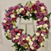 This arrangement features a variety of lavender and  white roses, mini