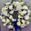 This standing blue and white wreath serves as an elegant remembrance for