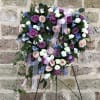This beautiful and petite, heart-shaped wreath of sky blue touches, lavender and