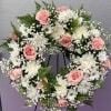This delicate combination of pink roses and white crysanthemums is a perfect