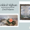 A folded afghan is a wonderful gift to celebrate and remember a