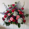 Beautiful deep colors red roses and burgundy daisies, pink roses and carnations