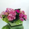 A luxurious and fresh springtime arrangement with bright green hydrangeas, dusty pink